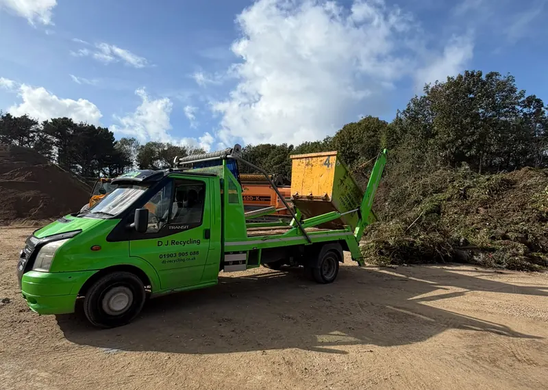 Green DJ Recycling vehicle at a waste-handling site